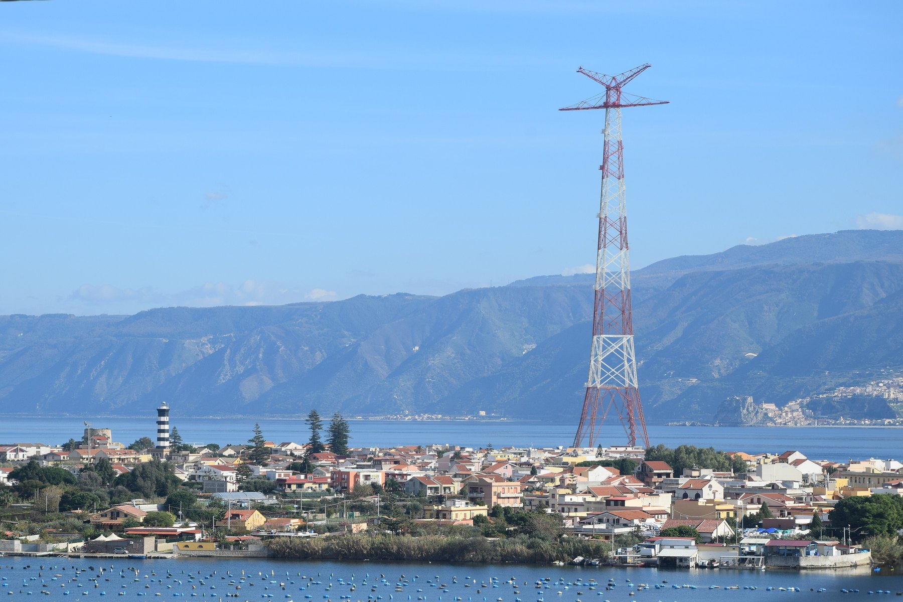 The Torre Faro pylon above the houses of Messina, with Calabria in the background