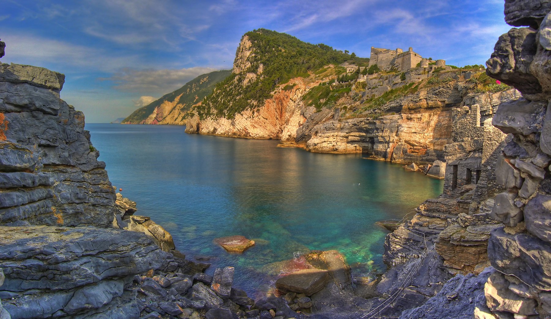 Byron's cave in Portovenere, with the green sea between the rocks