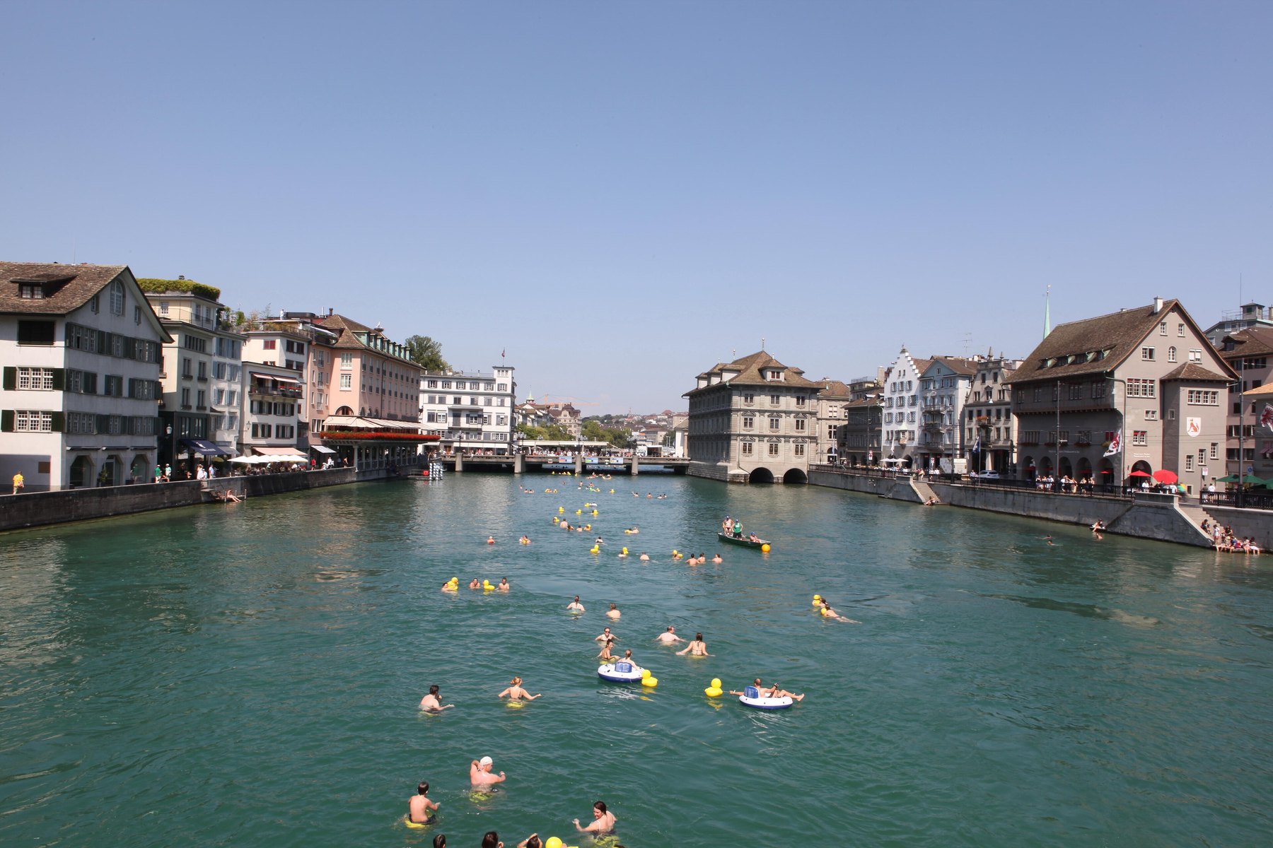 Swimmers in the Limmat in the center of Zurich, with the old town houses on the banks