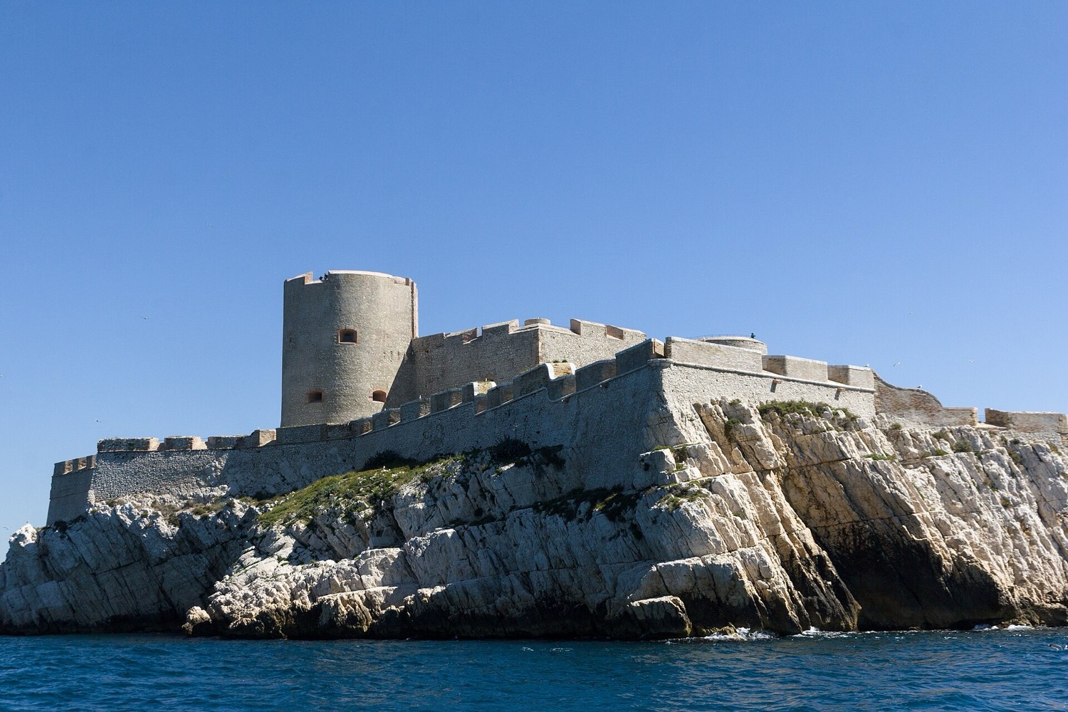 The Château d'If seen from the sea: a square fortress of light stone on a low rocky island