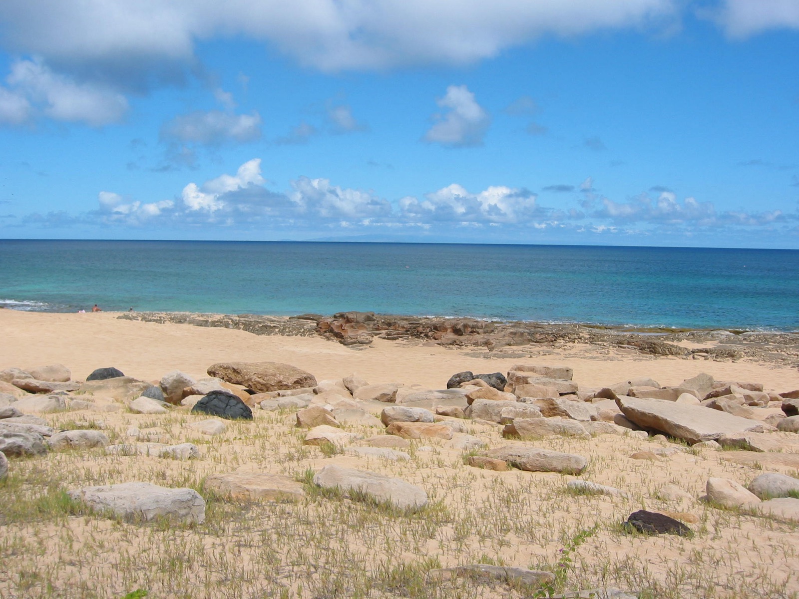 The rocky west coast of Molokai, with Oahu on the horizon across the channel.